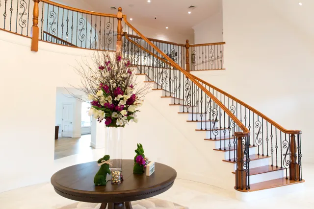 Finished oak staircase with iron balusters and a matching wood handrail